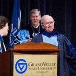 Faculty Member makes a joke during ceremony with Gayle Davis
